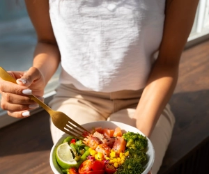 high-angle-woman-eating-salmon-bowl